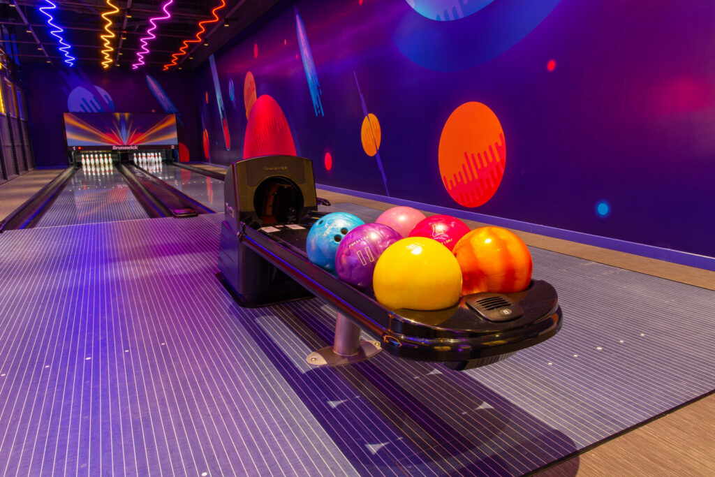 Completed bowling centre with lanes, ball returns and neon lighting ready for opening in Vietnam