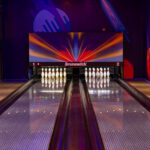 Two full size bowling lanes with synthetic lane beds, pin decks and overhead masking unit at a Vietnamese entertainment centre